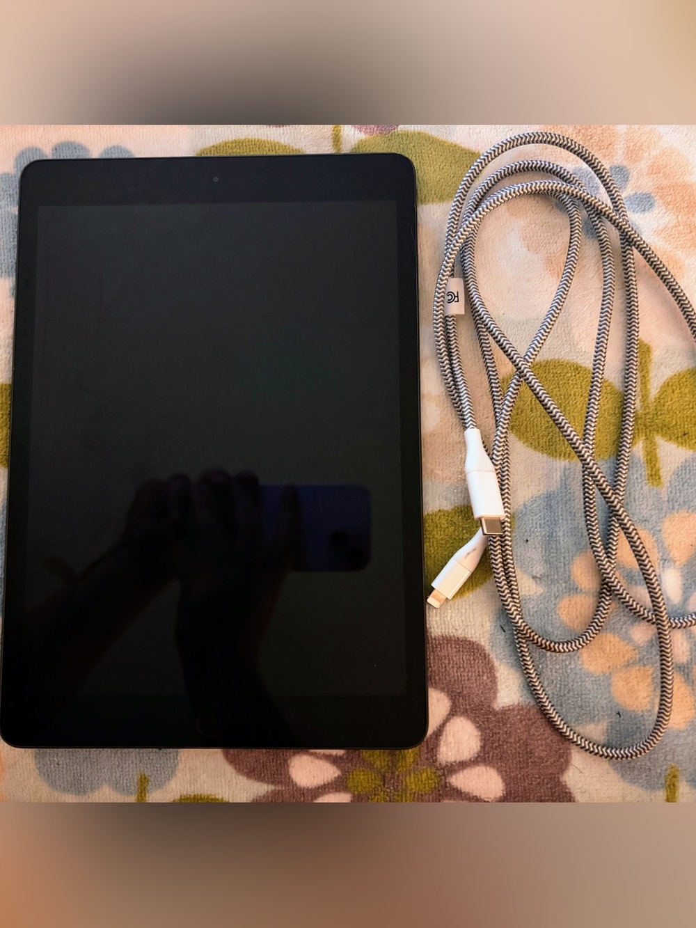 Apple Black Tablet with White and Black Braided Lightning Cable